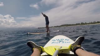 Guy paddle board handstand fail