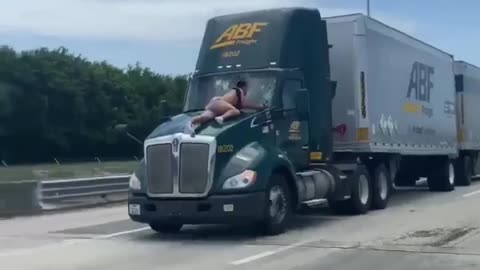 Viral video shows Florida man jump, hold onto the hood of a moving semi-truck