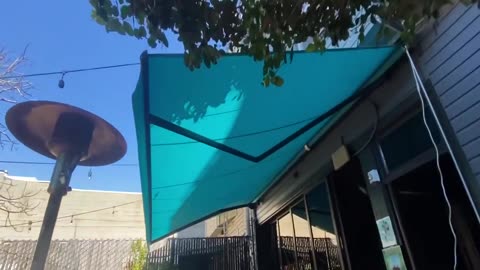 Patio retractable awnings for a bar in SF by Quayle & Company Awnings