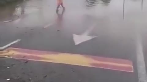 Malaysia flood light moment . Catching fish on highway