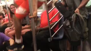 Guy white shirt red shorts dancing hanging subway train