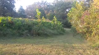 Driving an ATV on a Trail Around Country Duck Pond with Water Fountain Autumn Leave Scenic View