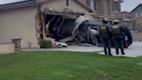 Moment when a car went airborne before crashing into a home garage in Jurupa Valley, California