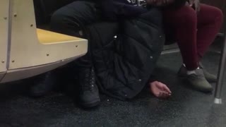 Two guys sleeping on a subway train