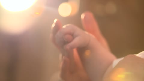 cute baby holding her daddy hand