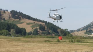 Series of Helicopters Fill Buckets to Fight Bridger Foothills Fire