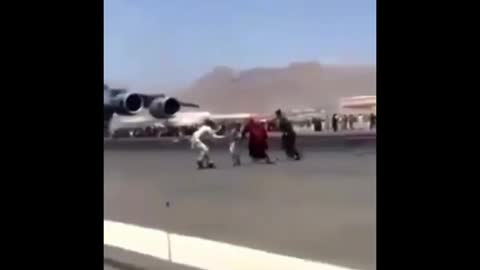 Afghans are clinging onto a C17 transporter on karzia Hamid Airport as they try to escape