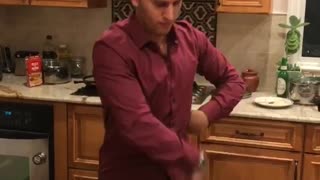 Music guy in red shirt dances in kitchen