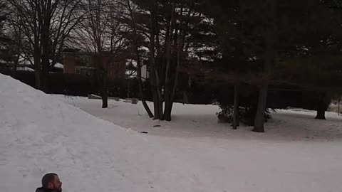 Guy in blue jacket shirt goes down snow hill falls backwards and folds scorpion