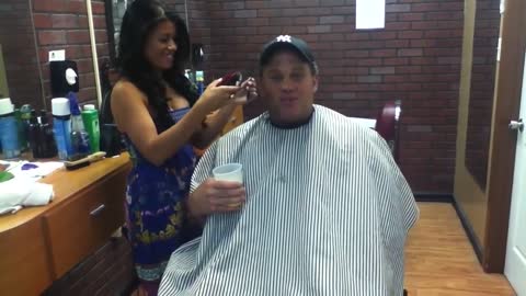 man drinks beer full of his hair at barber