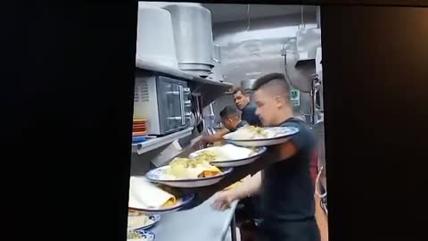 This waiter knows how to carry plates!