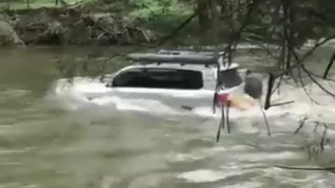 Vehicle Crosses Deep River