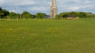 Walking towards an obelisk.