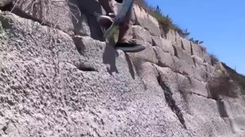 dude attempts to drop in on a sketchy rockface