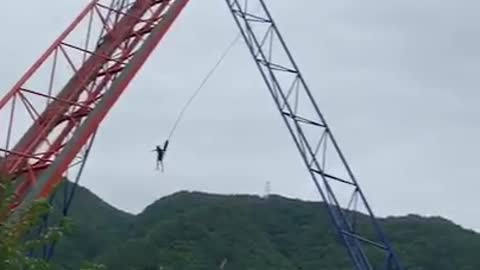 A man's success in bungee jumping.