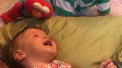 Big brother preciously makes baby sister laugh