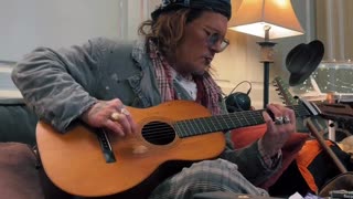 Johnny Depp strums to Smashing pumpkins