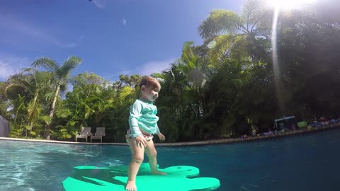 Cute little girl jumping into pool and floating!