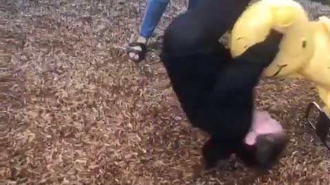 Little Girl On Rocking Seat At Park Falls Off Forward