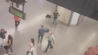 Jean jacket guy dances to guitarist in subway