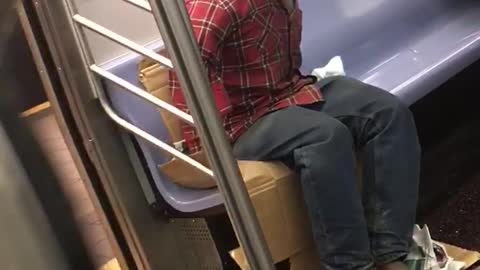 Headless red shirt guy rides subway someone takes picture of him