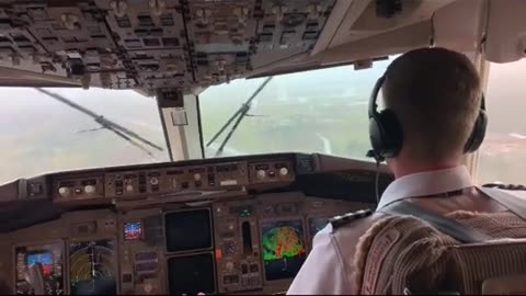 Pilot lands in turbulent weather with low visibility and rain.