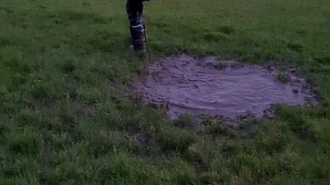 Kid Makes an Unexpected Jump into Mud Puddle