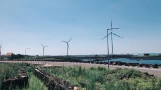 Jeju beach with windmill coastal road