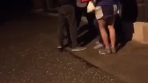 Girl in pink trying to break up fight bald guy misses headbutt