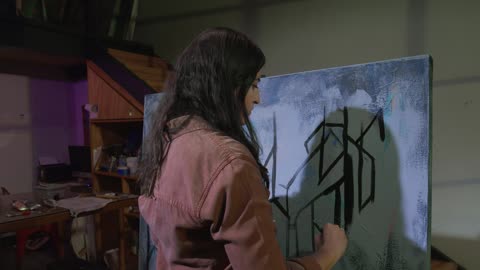 Skilled female artist painting a picture