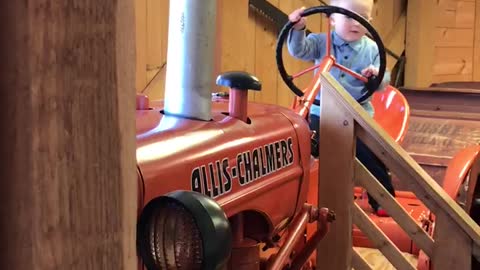 Little patriot rides tractor