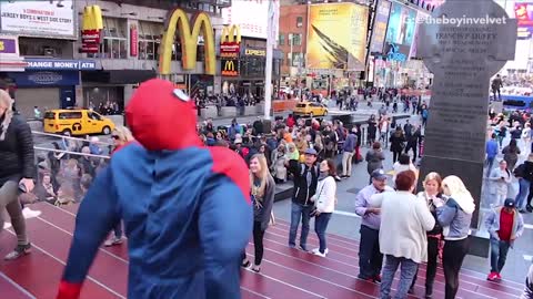 Man dressed as spiderman walks around times square