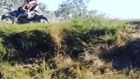 Shirtless man motorcycle fall cliff river