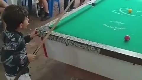 Child playing billiards !!