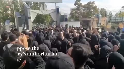 University security guards protect students in Sanandaj as Iranian security forces fire shots