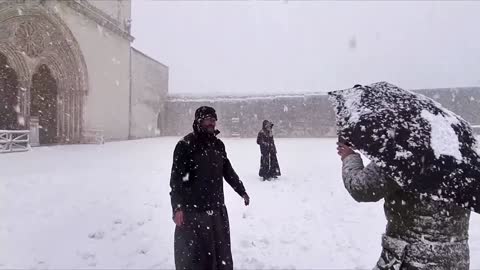 Delighted Assisi friars hurl snowballs at basilica