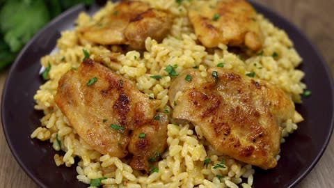 Creamy rice with chicken in a pan. Simple and delicious!