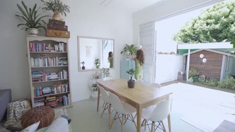 Woman Watering Her Indoor Plants