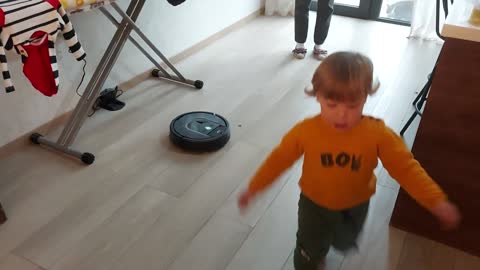 Funny Baby Scared by Roomba Vacuum Cleaner