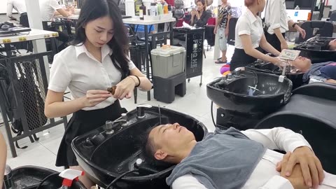 Her beauty and talent for massaging are undeniable, Vietnam Barbershop