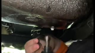 Daily routine of car oil draining and repairman