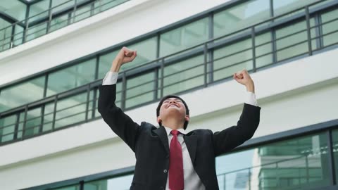 A excited and successful younger business man