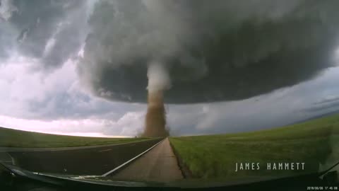 Storm chasing dashcam: Tornado crossing the highway! Laramie, Wyoming