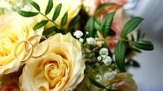 Wedding rings over yellow flowers