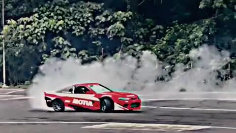 A GIRL DRIVING A SPORTS CAR