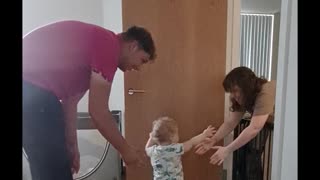 Excited Parents Encourage Son's First Steps