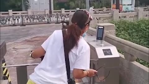 China, citizens go through security barrier to be able to enter their own neighbourhoods.