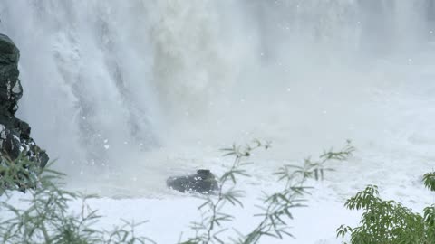 Water from a rocky waterfall falling to the bottom of a waterfall