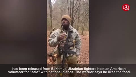Ukrainian soldiers host an American soldier with their national meal