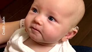 She was born deaf but had hearing device put in. First time she's heard her mom's voice